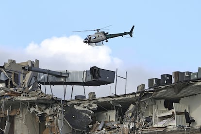 Un helicóptero sobrevuela los restos del edificio, este jueves. El alcalde de Surfside, Charles Burckett, dijo en rueda de prensa que, en su opinión, el derrumbamiento absoluto del ala noreste del edificio avecina que no habrá “tanto éxito” como esperaban para “encontrar a los desaparecidos con vida”.