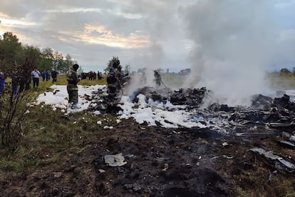 A handout photograph taken and released by Russian Investigative Committee on Aug. 23, 2023, shows rescuers working at the site of a plane crash near the village of Kuzhenkino, Tver region.