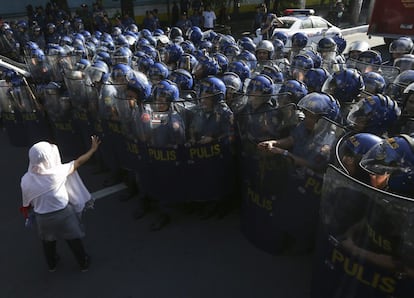 Policías antidisturbios vigilan una manifestación en contra de la celebración de la Cumbre de Líderes del Foro de Cooperación Económica Asia Pacífico (APEC), en Manila (Filipinas).