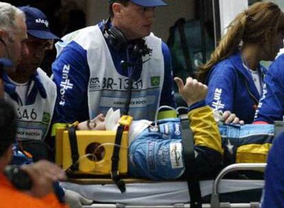 Fernando Alonso levanta el dedo pulgar de su mano derecha en señal de que está bien tras el accidente sufrido en Interlagos en 2003.