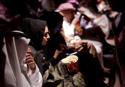 Una mujer come palomitas antes de la proyección de la película 'Black Panther'.