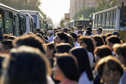 Viajeros en una parada de autobús en Santiago de Chile.