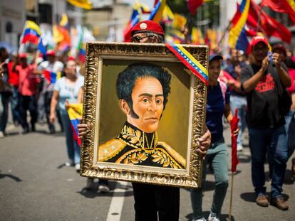 Un hombre sostiene un cuadro de Simón Bolívar durante una manifestación en Caracas (Venezuela) en 2019.