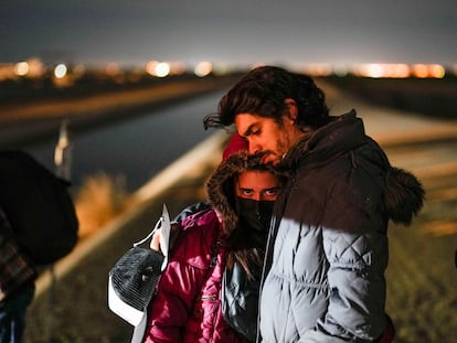 A couple from Cuba wait to be processed to seek asylum after crossing the border into the United States, Friday, Jan. 6, 2023, near Yuma, Ariz.