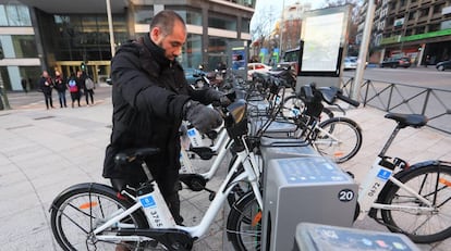 Un usuario recoge una bici de BiciMad en Plaza de España (Madrid).