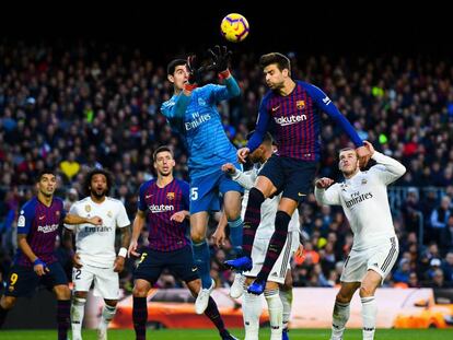 Courtois e Piqué disputam bola alta no primeiro clássico da temporada, no Camp Nou, quando o Barça venceu por 5 a 1.