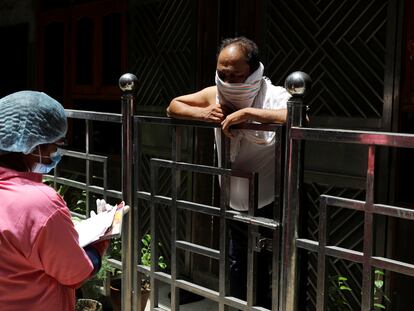 Un trabajador comunitario de la salud empleado por el Ministerio de Sanidad de la India realiza una encuesta puerta a puerta sobre la incidencia de la covid-19 en Nueva Delhi, India, el 26 de junio de 2020.