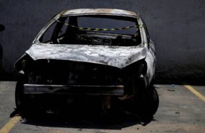 A burned car in which a body was found during searches for the Greek ambassador.