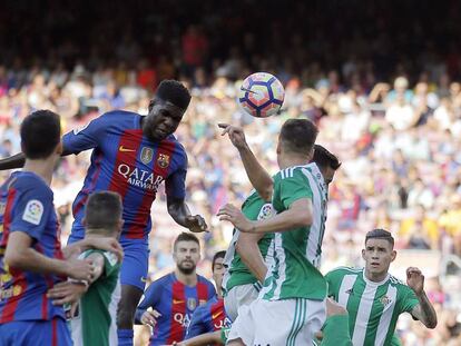 Samuel Umtiti cabeceia a bola no jogo entre Barcelona e Betis. / Manu Fernández (AP)