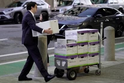 Documents related to the class-action lawsuit on behalf of investors who owned Tesla stock in August 2018 are loaded onto a cart outside of a federal courthouse in San Francisco, Tuesday, Jan. 17, 2023.