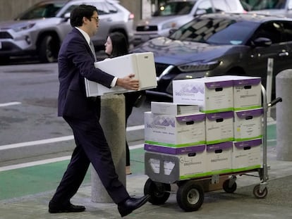 Documents related to the class-action lawsuit on behalf of investors who owned Tesla stock in August 2018 are loaded onto a cart outside of a federal courthouse in San Francisco, Tuesday, Jan. 17, 2023.