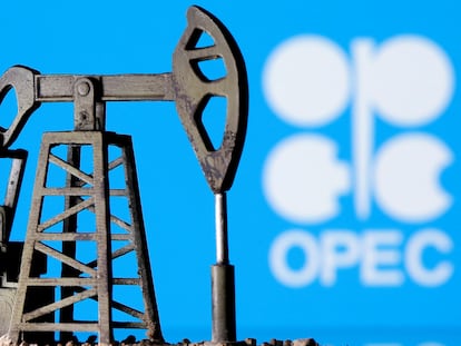 A 3D printed oil pump jack is seen in front of the OPEC logo