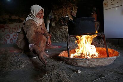 Miembros de la familia al-Hamadeh hacen fuego dentro de una cueva, adoptada como su nuevo hogar, al sur de Hebrón (Cisjordania).