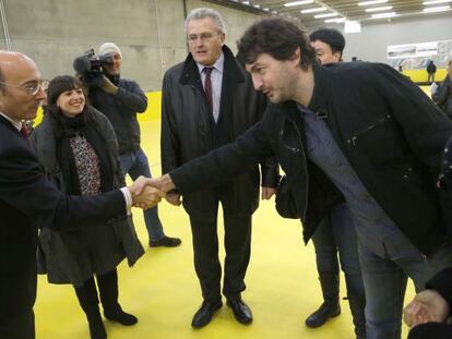 El delegado el Gobierno Carlos Urquijo saluda al diputado foral Iñaki Errazkin en las instalaciones de la nueva lonja de pesca de Pasaia.