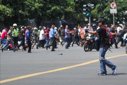 Imagen difundida por la Agencia de Noticias Xinhua de China, donde se ve a un hombre no identificado con un arma en la calle Thamrin cerca del centro comercial donde se ha producido el ataque en Yakarta, Indonesia.