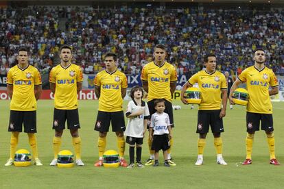 Los jugadores del Corinthians, sobre las réplicas del casco usado por el piloto de Fórmula 1 Ayrton Senna antes de su Copa do Brasil partido contra el Nacional AM en el estadio Arena Amazonas en Manaus, 30 de abril de 2014. El Corinthians rindió homenaje a Senna en la víspera del 20º aniversario de su muerte, durante una carrera de F1 en Imola, Italia.