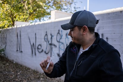 An NGO worker finds a used syringe while cleaning up waste left behind by addicts, in Nogales, Arizona, in December.