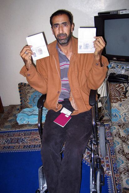 Ahmed Gachbar Baillal shows his and his father's passport, both of which are Spanish, in his house in Laayoune.