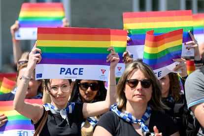 Mujeres sostienen banderas a favor de la paz y la comunidad LGTBIQ+.