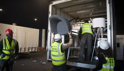 Diversos operaris carregant un camió amb mobiliari donado en el MWC.
