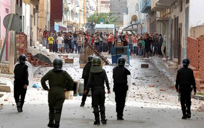 Los manifestantes marroquíes tiran piedras contra las fuerzas de seguridad en Imzouren, cerca de Alhucemas.