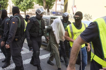 Civil Guard agents with a terror suspect in Lleida in July.