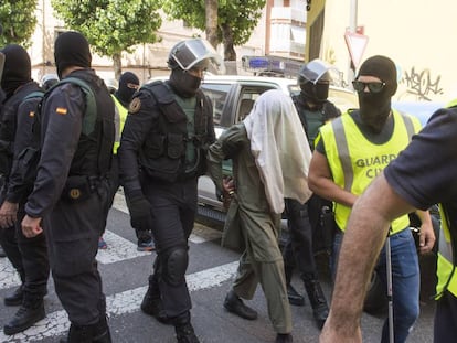 Civil Guard agents with a terror suspect in Lleida in July.