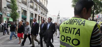 Un "hombre anuncio" con un cartel de compra y venta de oro.