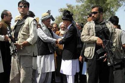 El presidente afgano, Hamid Karzai (en el centro, a la derecha) saluda al primer ministro, Shaukat Aziz, ayer en la inauguración de una carretera en Nangarhar.