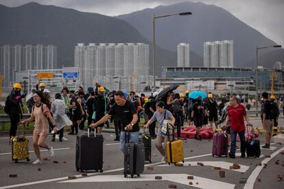 Una multitud de pasajeros empujan sus maletas tras el bloqueo de las carreteras que conducen al aeropuerto internacional de Hong Kong, el 1 de septiembre de 2019.