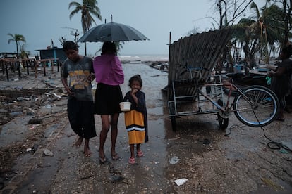 Uma família caminha pelo bairro de Didilandia, na costa de Bilwi, capital da Região Autônoma da Costa Caribe Norte da Nicarágua, em 22 de novembro de 2020. Essa área foi uma das mais afetadas pelo furacão Iota.