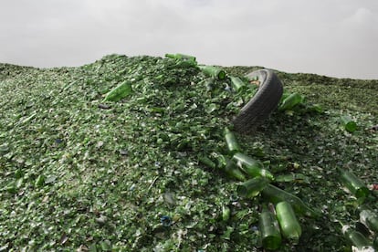 In this Sunday, Jan. 24, 2016 photo, broken glass bottles later to be recycled at the Phoenicia Glass Works Ltd. factory in the southern Israeli town of Yeruham. Tiny shards, millions of them, are piled into rolling hills of green and brown. They are 50 feet high and span the length of a few soccer fields. This is the junkyard at Israelx92s only glass container factory, where broken glass awaits a new life. (AP Photo/Oded Balilty)