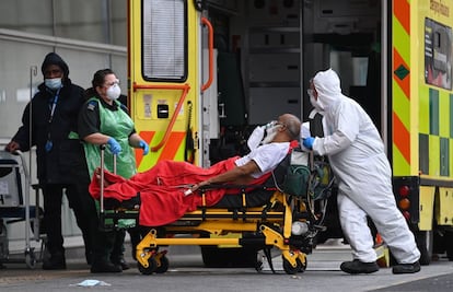 Los sanitarios trasladan a un paciente de coronavirus desde una ambulancia al Hospital Real de Londres. El Reino Unido informó este jueves de que ya ha administrado más de cinco millones de dosis de la vacuna contra la covid-19 desde que empezó su campaña de inmunización, a principios de diciembre.