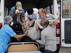 Healthcare workers and relatives carry Shashikantbhai Parekh, a patient with breathing problem, out from an ambulance for treatment at a COVID-19 hospital, amidst the spread of the coronavirus disease (COVID-19) in Ahmedabad, India, April 28, 2021. REUTERS/Amit Dave