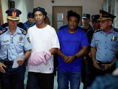 Ronaldinho y su hermano Roberto de Assis Moreira, escoltados por agentes paraguayos, en Asunción.