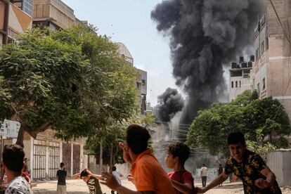 Jóvenes palestinos corren para ponerse a salvo tras un ataque aéreo israelí.