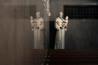 St. Anthony holding the infant Jesus is reflected in a wall in St. Aloysius Catholic Church