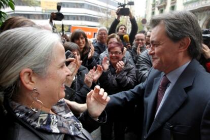 El lider de CiU, Artur Mas, vencedor en las elecciones autonómicas celebradas ayer saluda a una compañera a su llegada esta mañana a la sede convergente