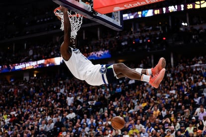 El escolta de los Minnesota Timberwolves Anthony Edwards se cuelga del aro tras un mate en el segundo cuarto del partido de este lunes contra los Denver Nuggets.