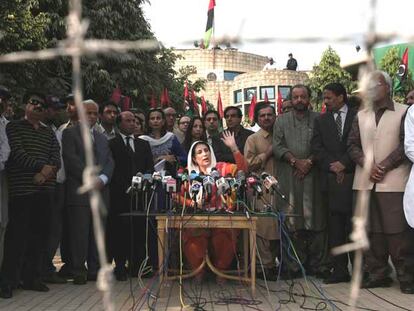 La opositora Benazir Bhutto se dirige a la prensa frente a su domicilio, en Lahore, rodeada de colaboradores.