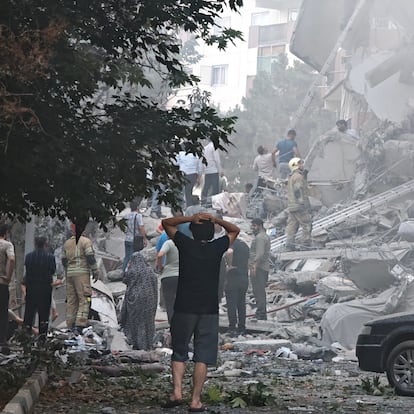 TEHRAN, IRAN - JUNE 13: People look over damage to buildings in Nobonyad Square following Israeli airstrikes on June 13, 2025 in Tehran, Iran. Iran's three top military generals were killed in the attacks that also targeted nuclear and military facilities, according to published reports. Israel described the strikes as preemptive to keep Iran from obtaining nuclear weapons, the reports said. (Photo by Majid Saeedi/Getty Images)