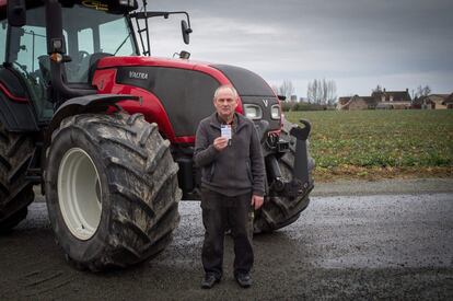 Claude Guillon, 65, retired farmer, married with two children, living in Monthodon, central France, poses with his voting card in Monthodon, on February 25, 2017.
What should be the priorities of the next French president?
"The president ought to be dignified, have common sense and represent France properly. He should not govern on a day-to-day basis. He should think about future generations and the future of France, Europe's biggest farming country,  by giving priority to French produce and banning the import of GMO products. He should also make life easier for businesses. Every day they grapple with restrictive regulations, cumbersome administrative hurdles and high social security costs that hold back small businesses, a symbol of our rural fabric, and act to the detriment of all workers.
 / AFP PHOTO / GUILLAUME SOUVANT / RESTRICTED TO EDITORIAL USE - RESTRICTED TO FRENCH ELECTIONS ILLUSTRATION PURPOSE