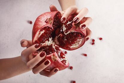 Beautiful women’s hands with dark red manicure