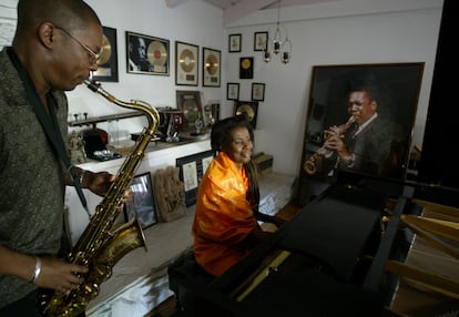 Ravi Coltrane rehearses with his mother, Alice Coltrane, in front of a portrait of John Coltrane, at her home in 2004.