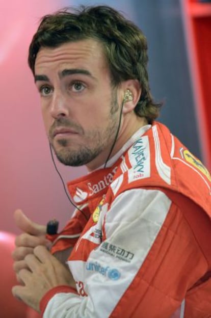 Fernando Alonso relaxes at the Ferrari pits at the Interlagos circuit on Friday.