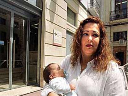 Rocío del Pilar, con su hijo Edwin en brazos, a las puertas de un centro sanitario de Alicante.