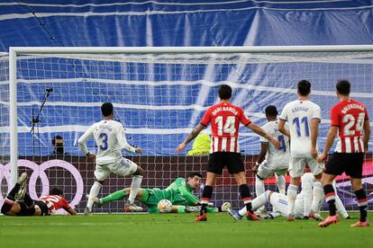 Courtois saca el balón bajo palos ante una jugada de ataque del Athletic en el Bernabéu.