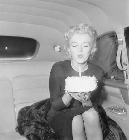 Marilyn Monroe soplando una vela por su 30 cumpleaños.