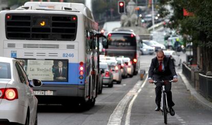 A man rides a bicycle in downtown Madrid.