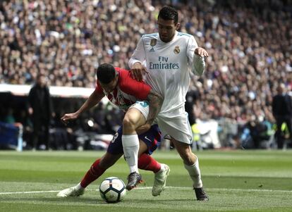 El jugador del Atlético Vitolo sujeta la pierna de Kovacic durante el partido.